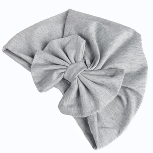 Light gray cotton baby turban hat featuring a large soft bow detail on white background