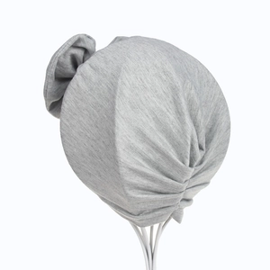 Detail of grey marl cotton baby turban hat featuring a large soft decorative bow