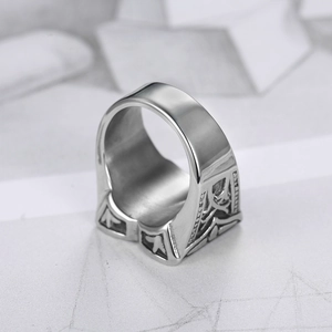 Detailed macro view showing vintage embossed textures on silver stainless steel wide ring