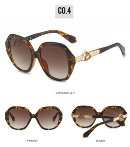 Detail view of oval tortoiseshell sunglasses with gold hollow metal temples and brown lenses