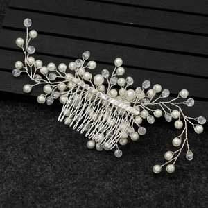 Detailed macro view of handmade silver bridal hair comb with pearls and crystals