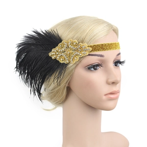 Detail of 1920s vintage feather headband with gold sequins and rhinestones on mannequin