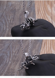 Macro view of vintage stainless steel Triceratops skeleton pendant and twisted rope chain