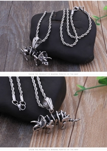 Detail of silver triceratops skeleton pendant with vintage finish on a twist chain