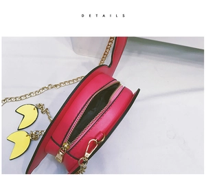 Detail of pink flamingo crossbody bag featuring zipper closure and golden chain strap