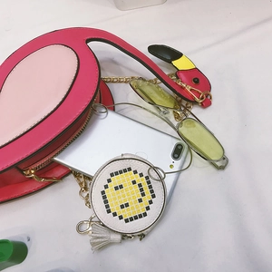 Pink flamingo crossbody bag with small pixel smiley pouch and accessories