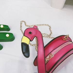 Detailed view of pink flamingo crossbody bag with golden chain strap and zip closure