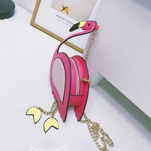 Detail of pink flamingo crossbody bag with golden chain strap and unique feet charms