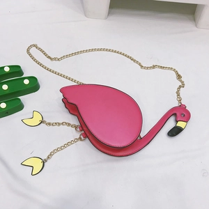 Close-up of a pink flamingo shaped crossbody bag with gold chain and cactus decor