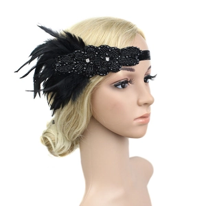 Close-up of black feather headband with intricate beadwork and rhinestones on a model