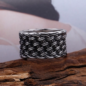 Vintage braided titanium steel ring for men with antique silver finish on wood