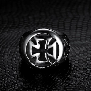 Detailed close-up of a vintage steel biker ring featuring a gothic iron cross design