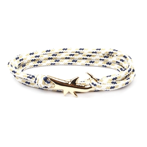 Close-up of golden shark-shaped metal clasp on multi-layer braided rope bracelet
