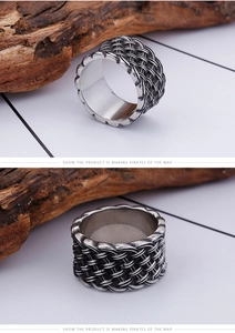 Macro detail of vintage titanium steel wide ring with braided texture and oxidized finish