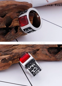 Macro detail of men's vintage steel ring with red stone and Sanskrit engraving