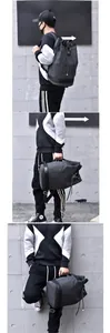 Detail of dark grey canvas duffel backpack with brown leather handles and drawstring closure