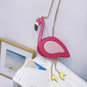 Detail of pink flamingo shaped shoulder bag with golden chain and leg tassels