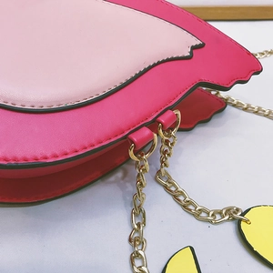 Close-up of pink flamingo shoulder bag with golden chain strap and detailed stitching