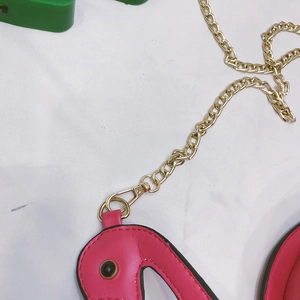 Pink flamingo shoulder bag detail with gold metal chain strap and premium PU material