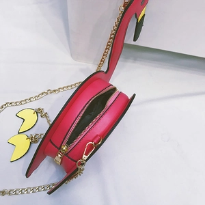 Detail view of pink flamingo crossbody bag showing gold chain strap and inner zipper