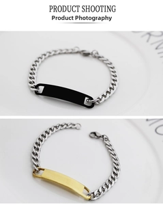 Detailed view of silver Cuban chain bracelets with black and gold metal ID bars