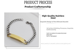 Detail of polished stainless steel Cuban chain bracelet with golden ID plate and lobster clasp