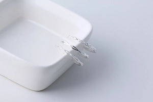 Detailed view of three minimalist S925 silver rings with hollow out and twisted patterns