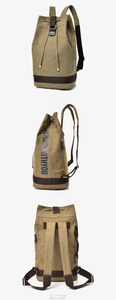 Detail of khaki canvas bucket backpack featuring drawstring closure and side zipper access