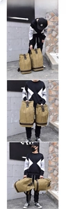 Detail view of khaki canvas barrel bag with leather straps and drawstring closure