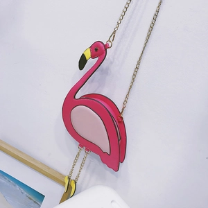 Detail of pink flamingo crossbody bag featuring gold chain strap and PU leather texture