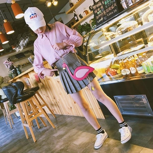 Pink flamingo shaped crossbody bag with metal chain shown in a trendy college outfit