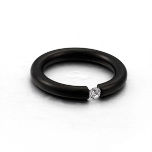Minimalist black matte titanium ring with a brilliant round-cut zircon stone centerpiece