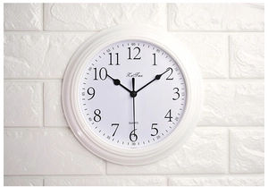Detailed macro of white silent wall clock featuring a clear quartz movement dial