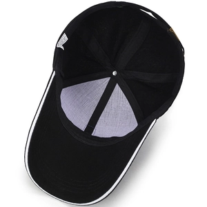 Interior view of black and white cotton baseball cap showing lining and metal buckle