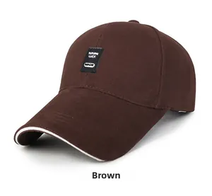 Detail of coffee brown cotton baseball cap showing woven patch and white sandwich brim