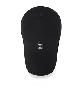 Top view of black cotton baseball cap showing six-panel stitching and square patch