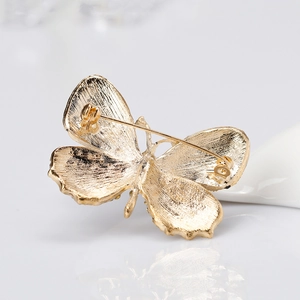 Golden butterfly brooch with sparkling crystals and secure rotating safety clasp