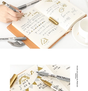 Detail of Baoke MP550 gold and silver metallic markers with soft fiber tips on paper