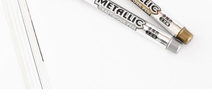 Detailed shot of gold and silver metallic craftwork pens for cards and signatures