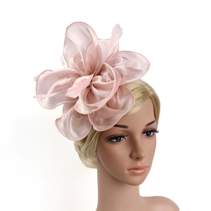 Detailed view of a soft pink organza fascinator hat with elegant feathers for weddings
