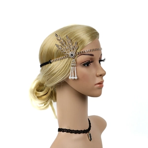 Detail of 1920s gold flapper headband with rhinestones and pearl tassel on a model