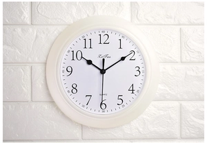 Detail view of silent wall clock with bold black 3D numbers and minimal matte frame