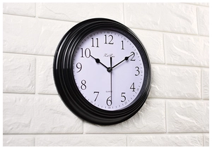 Side view of 9-inch silent wall clock with black frame and clear Arabic numerals