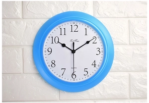 Detailed front view of a 9-inch light blue silent wall clock with black 3D Arabic numerals