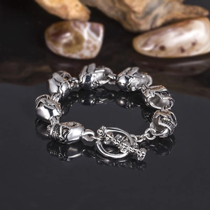 Punk style stainless steel skull link bracelet with OT clasp on dark reflective surface