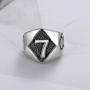 Detail of vintage punk skull ring for men with engraved lucky number 7 in steel finish