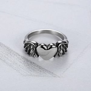 Vintage stainless steel heart ring with detailed wings in a retro punk gothic style