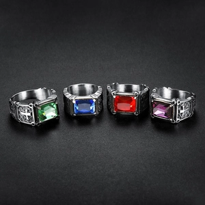 Detail of vintage skull rings with green, blue, red, and purple gems and cross relief