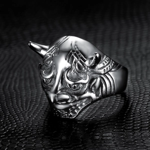 Close-up of Japanese Hannya mask ring in antique silver finish on black leather texture