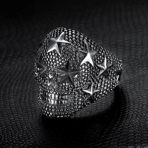 Macro shot of gothic stainless steel skull ring with star pattern on black leather